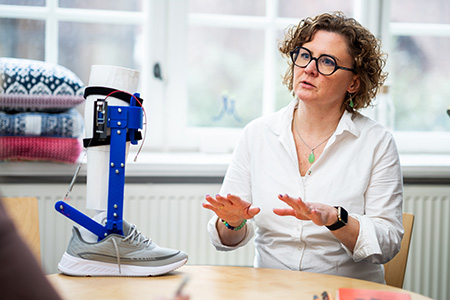 Woman at table with technical device