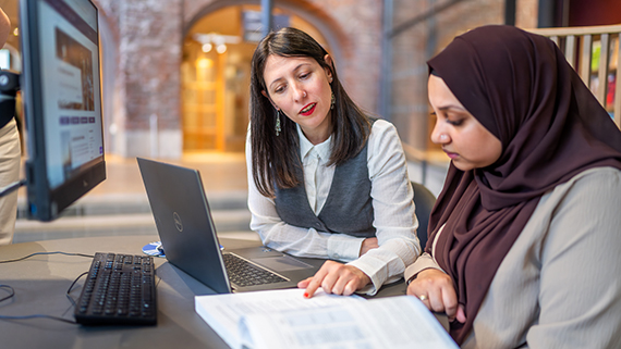 Student and teacher in the library.