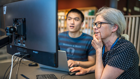 Student and teacher in the library.