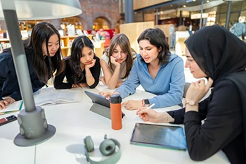 Students looking at a computer. 